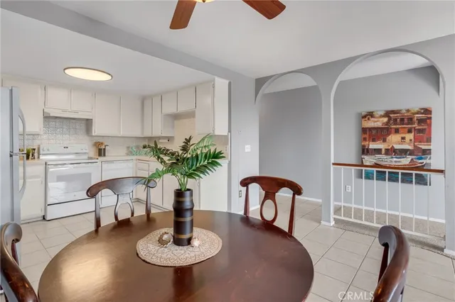 a kitchen with dining table and chairs