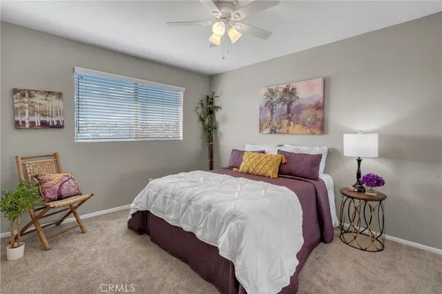a bedroom with bed and a chandelier