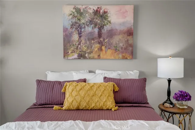 a living room with a couch and a potted plant