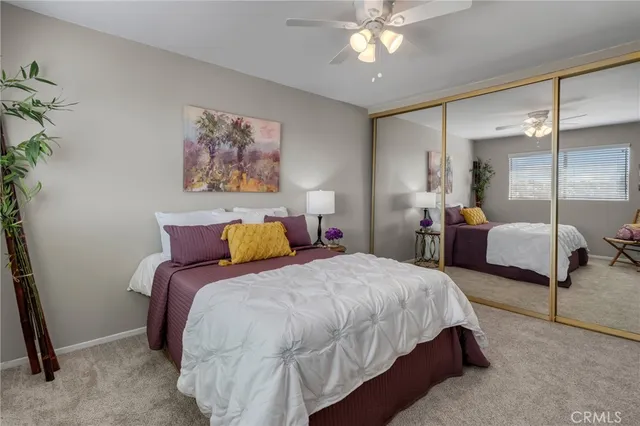 a bedroom with bed and a chandelier