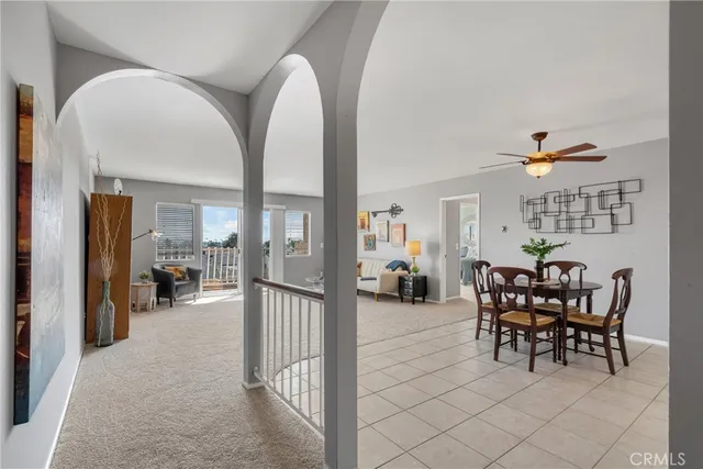 a view of a livingroom with dining room and furniture