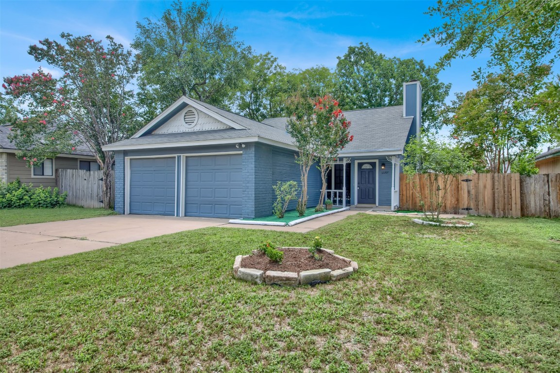 12307 Emery Oaks Road Austin, TX 78758 - Photo 1 of 1 a front view of a house with a yard and garage