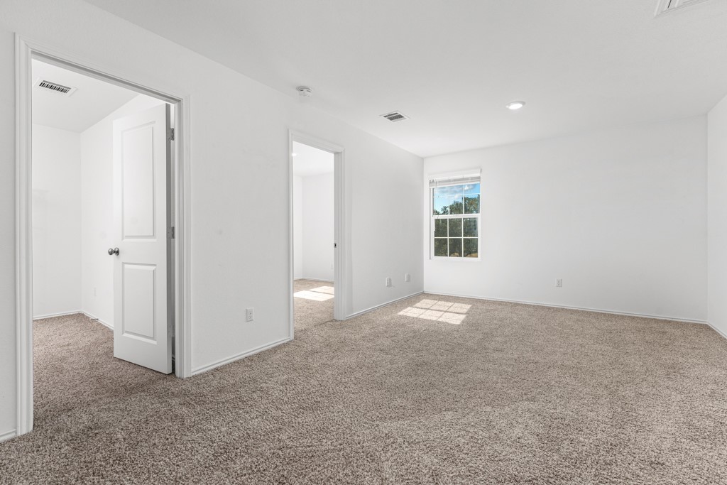 205 Rooster Way Jarrell, TX 76537 - Photo 12 of 29 Unfurnished bedroom with carpet and recessed lighting
