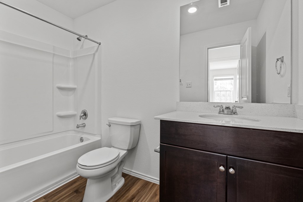 205 Rooster Way Jarrell, TX 76537 - Photo 13 of 29 Full bath featuring shower / bathtub combination, dark wood-style flooring, and vanity
