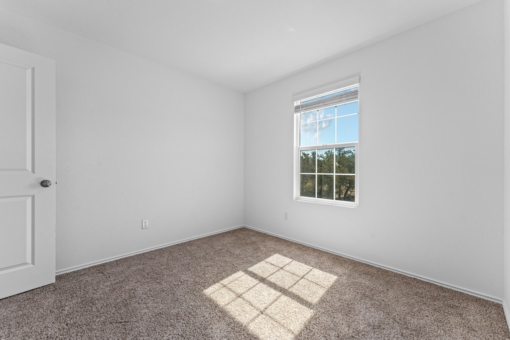 205 Rooster Way Jarrell, TX 76537 - Photo 15 of 29 Carpeted empty room with baseboards
