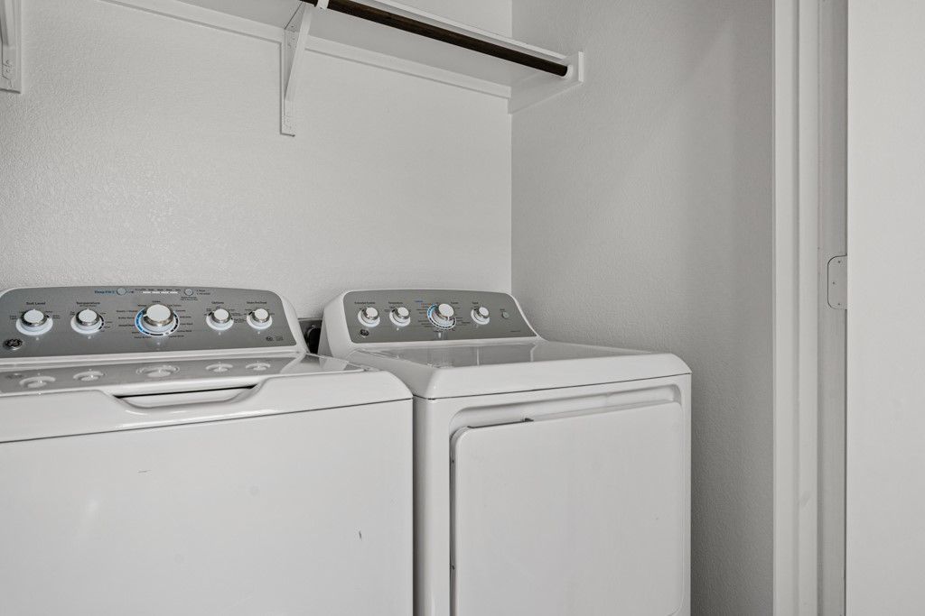 205 Rooster Way Jarrell, TX 76537 - Photo 17 of 29 Washroom with a textured wall and washer and clothes dryer