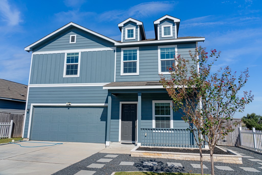 205 Rooster Way Jarrell, TX 76537 - Photo 25 of 29 View of front of house featuring covered porch, an attached garage, and driveway