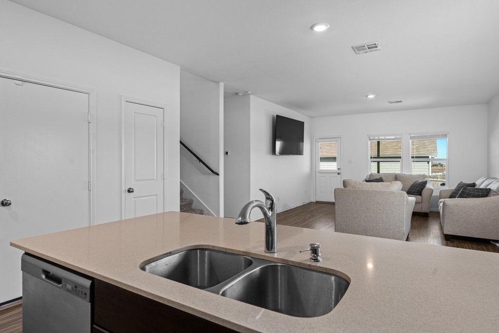 205 Rooster Way Jarrell, TX 76537 - Photo 29 of 29 Kitchen with dark wood-style flooring, stainless steel dishwasher, recessed lighting, light stone counters, and open floor plan