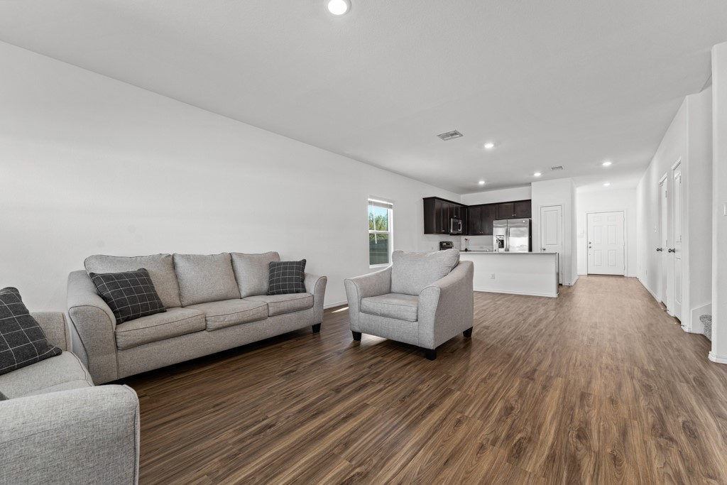 205 Rooster Way Jarrell, TX 76537 - Photo 6 of 29 Living area featuring recessed lighting and dark wood-style floors