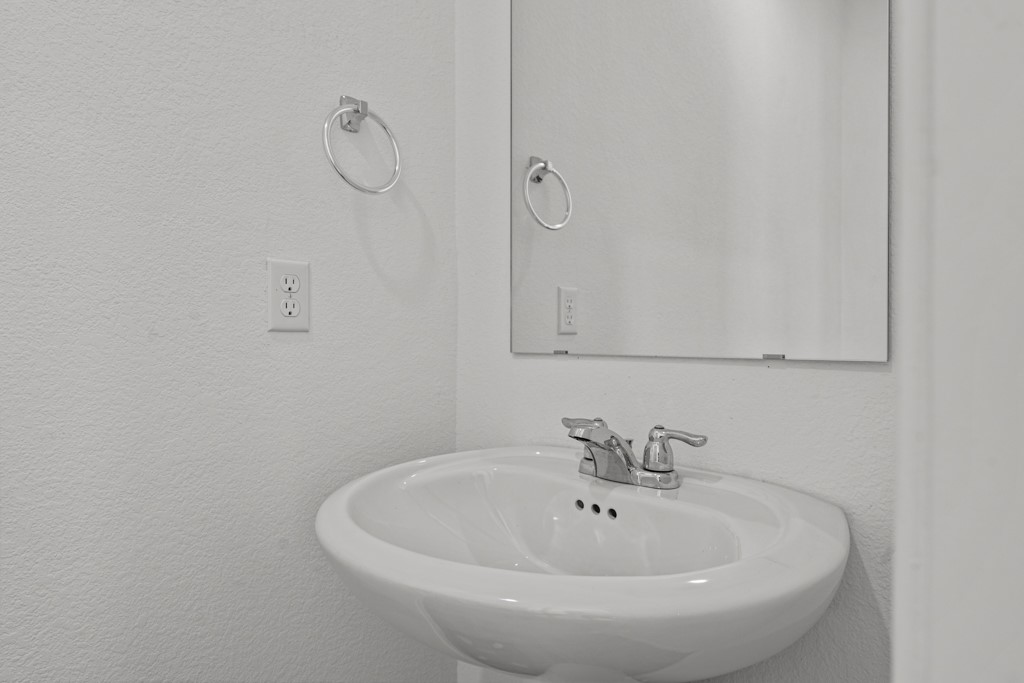 205 Rooster Way Jarrell, TX 76537 - Photo 8 of 29 Bathroom featuring a textured wall and a sink