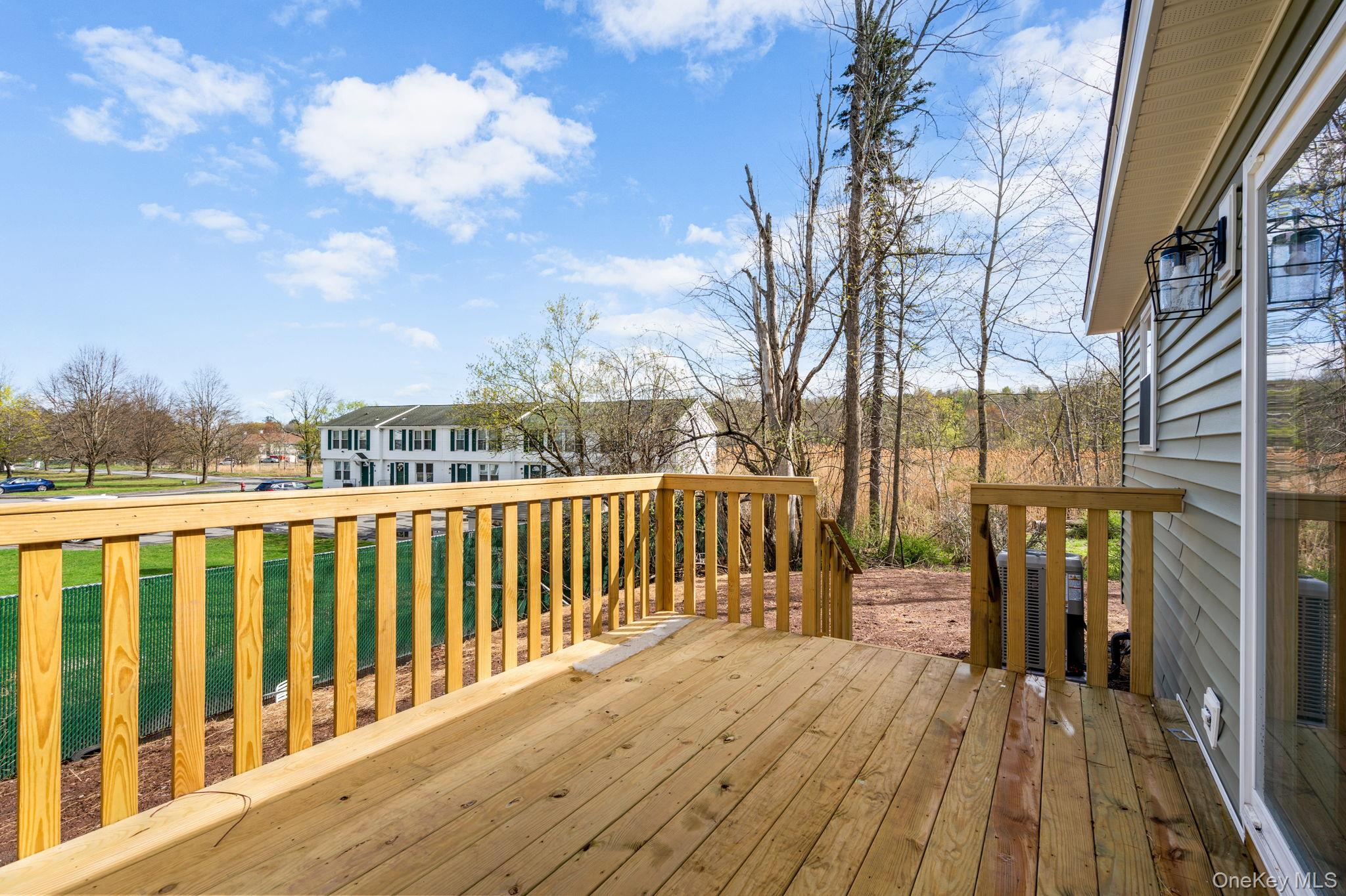 23 Spring Street Monticello, NY 12701 - Photo 29 of 44 a view of balcony with wooden floor and fence