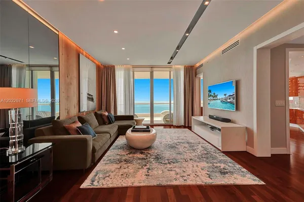 a living room with furniture and a flat screen tv