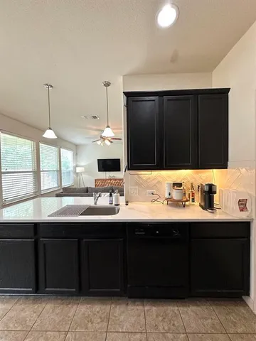 a kitchen with a sink and cabinets