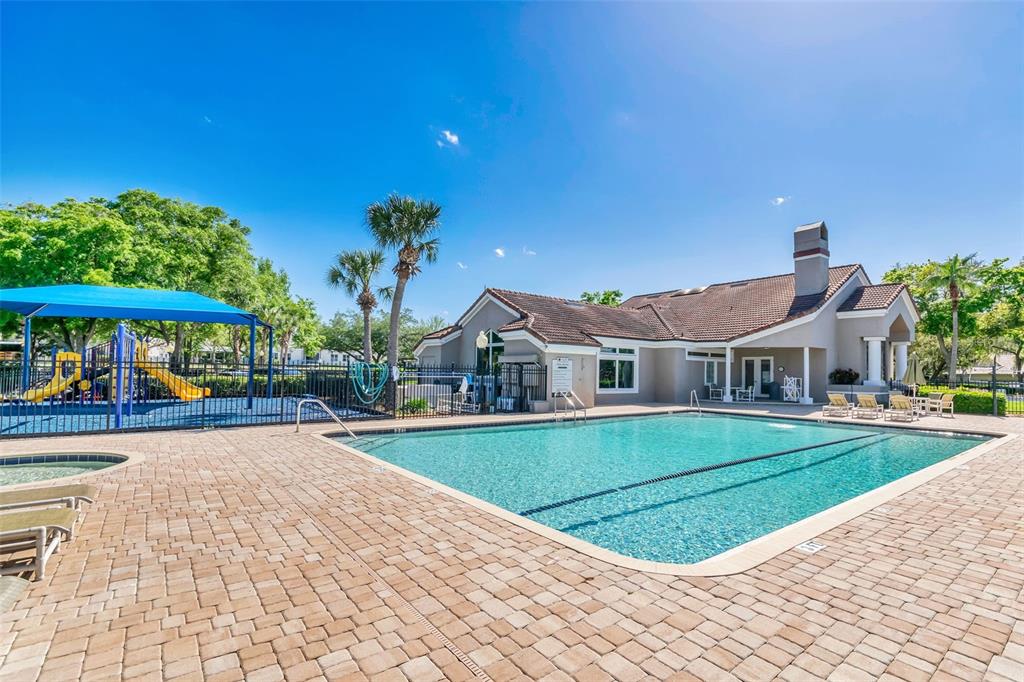 7432 Sparkling Lake Road Orlando, FL 32819 - Photo 49 of 54 a view of a house with a yard and potted plants