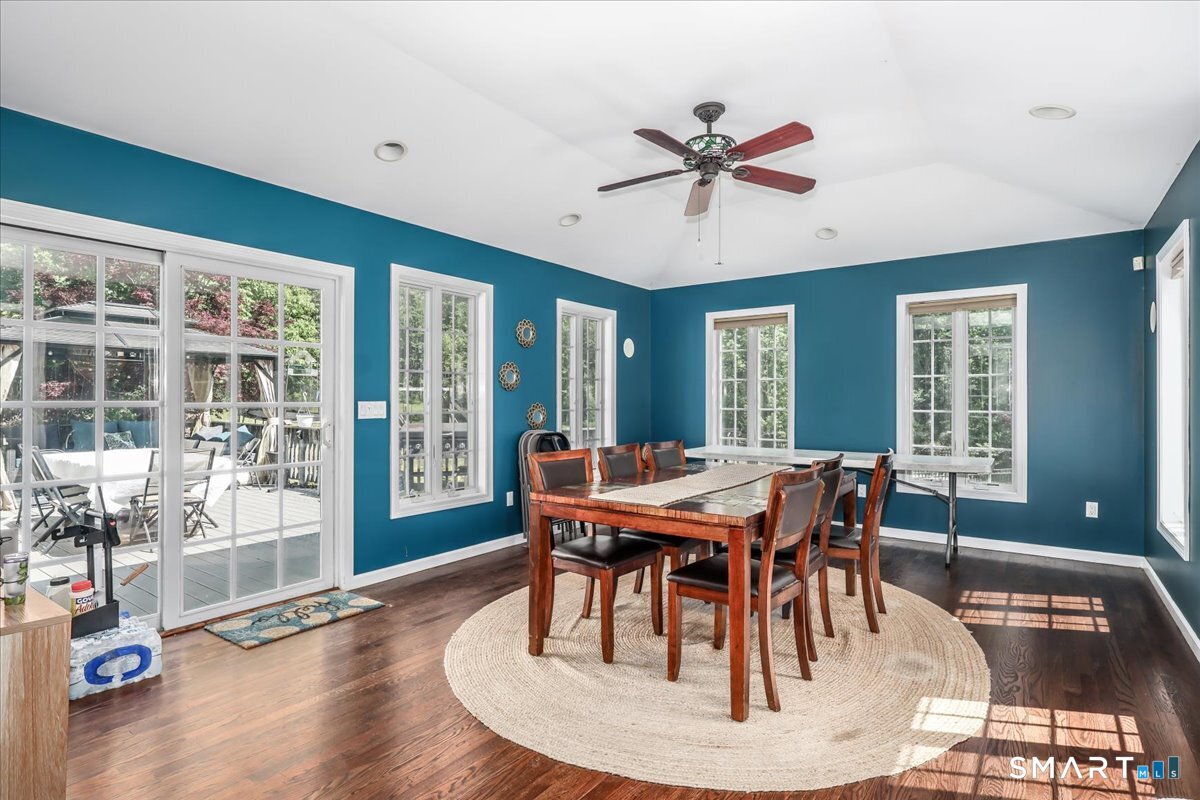 55 A Flax Hill Road Brookfield, CT 06804 - Photo 14 of 40 a dining room with wooden floor a chandelier a wooden table and chairs