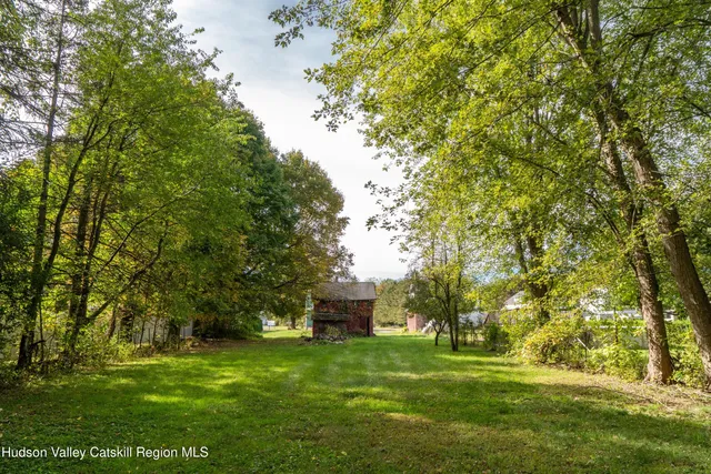 a view of a backyard with large trees
