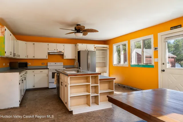 a kitchen with a stove a sink and cabinets