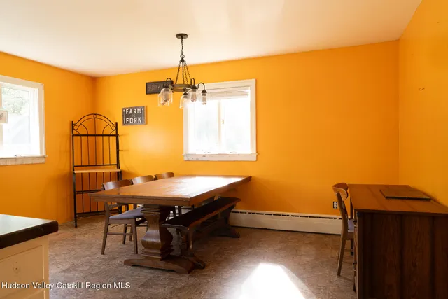 a dining room with a table and chairs