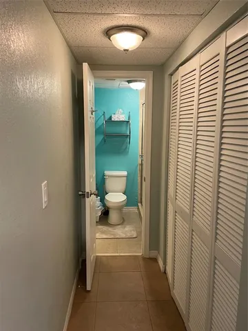 a view of a room with wooden floor and ceiling fan