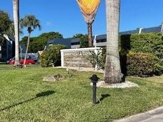a view of a livingroom with a chandelier furniture and windows
