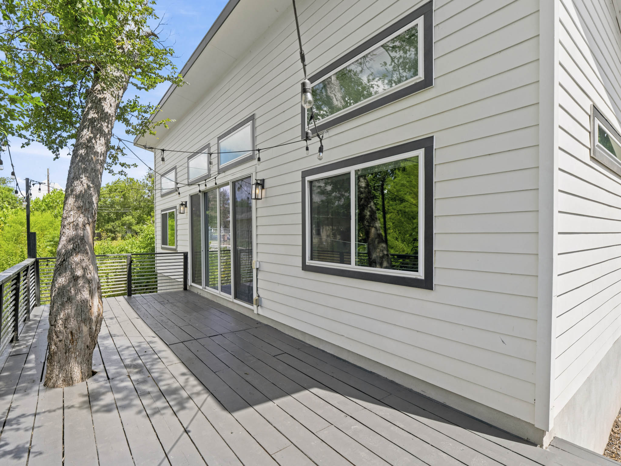 5005 Lott Avenue, Unit 2 Austin, TX 78721 - Photo 17 of 25 An inviting wood deck extends a spacious outdoor living area, perfect for entertaining.