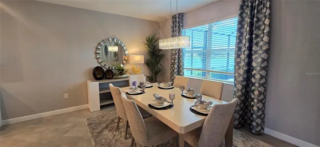 a view of a dining room that has a table and chairs in it