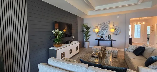 a living room with furniture and a potted plant