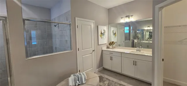 a bathroom with a double vanity sink and mirror