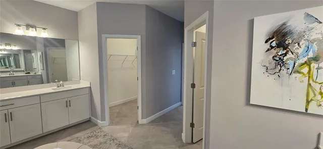 a bathroom with a double vanity sink and a mirror