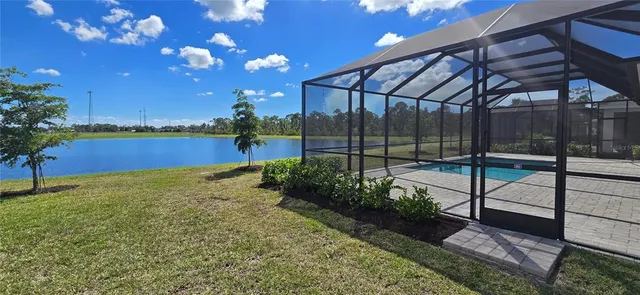 a view of a roof deck with a chair and tables