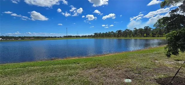 a view of a patio with table and chairs and a barbeque