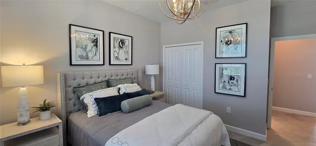 a bedroom with a bed and a chandelier