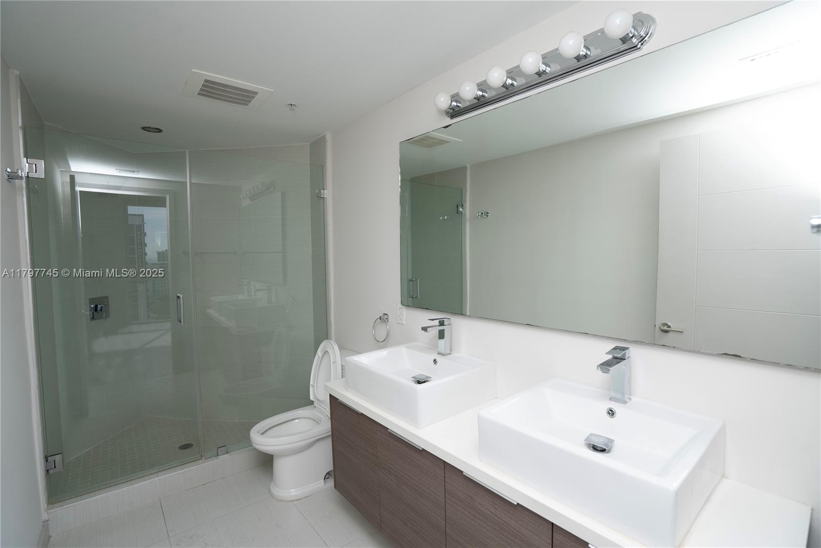 1010 Southwest 2nd Avenue, Unit 1703 Miami, FL 33130 - Photo 12 of 24 a bathroom with a sink a toilet and shower