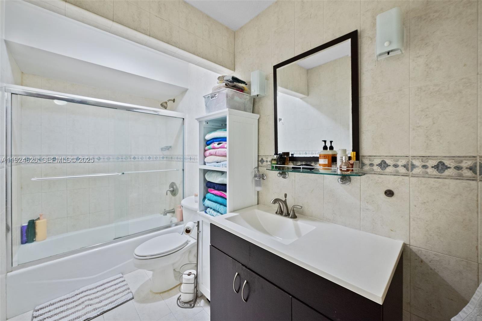 11840 Southwest 80th Street, Unit 526 Miami, FL 33183 - Photo 11 of 25 a bathroom with a sink a toilet and shower