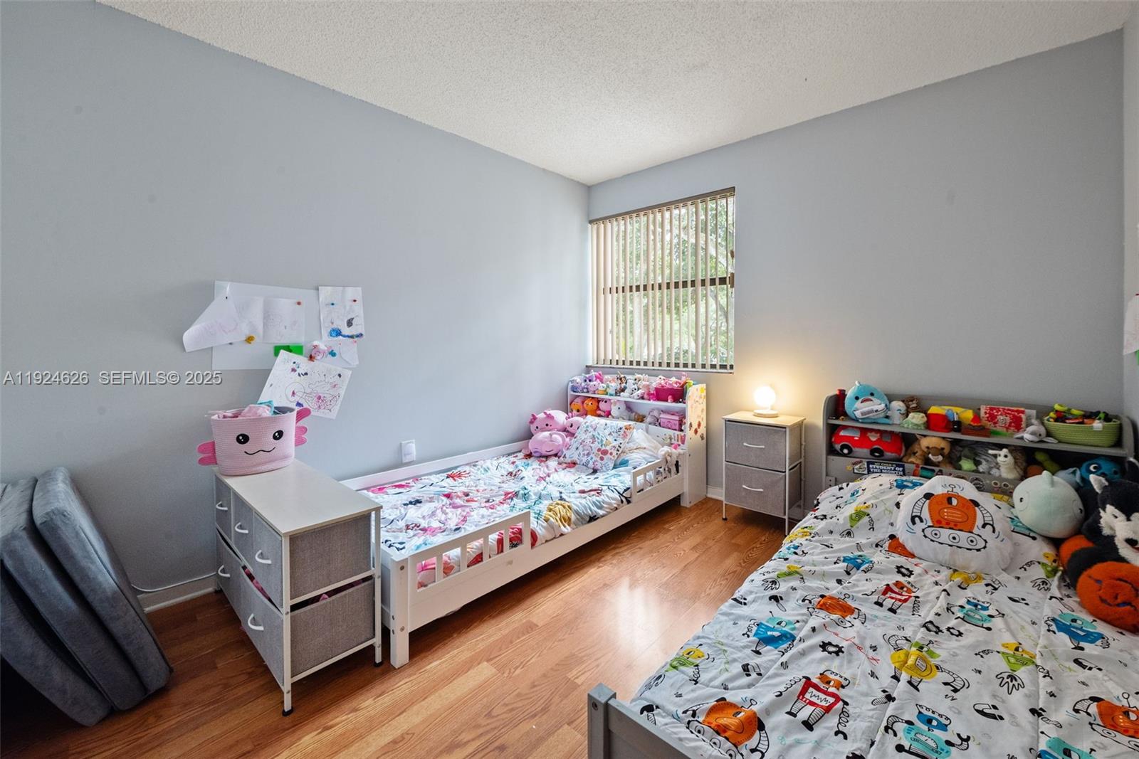 11840 Southwest 80th Street, Unit 526 Miami, FL 33183 - Photo 12 of 25 a bedroom with baby bed and window