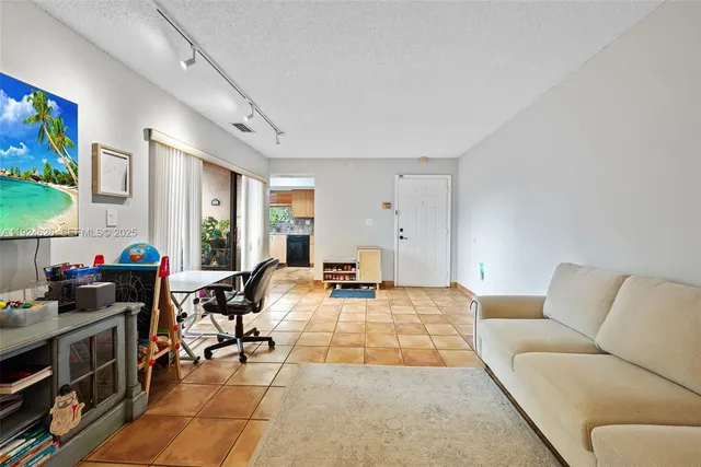 a view of a livingroom with furniture and a flat screen tv