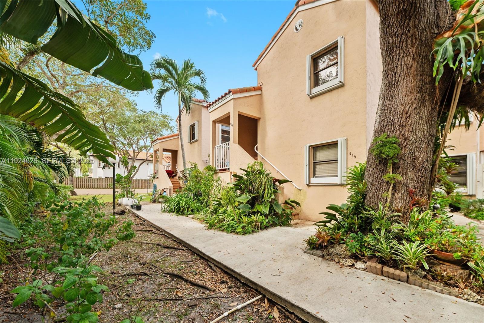 11840 Southwest 80th Street, Unit 526 Miami, FL 33183 - Photo 2 of 25 a front view of a house with a yard