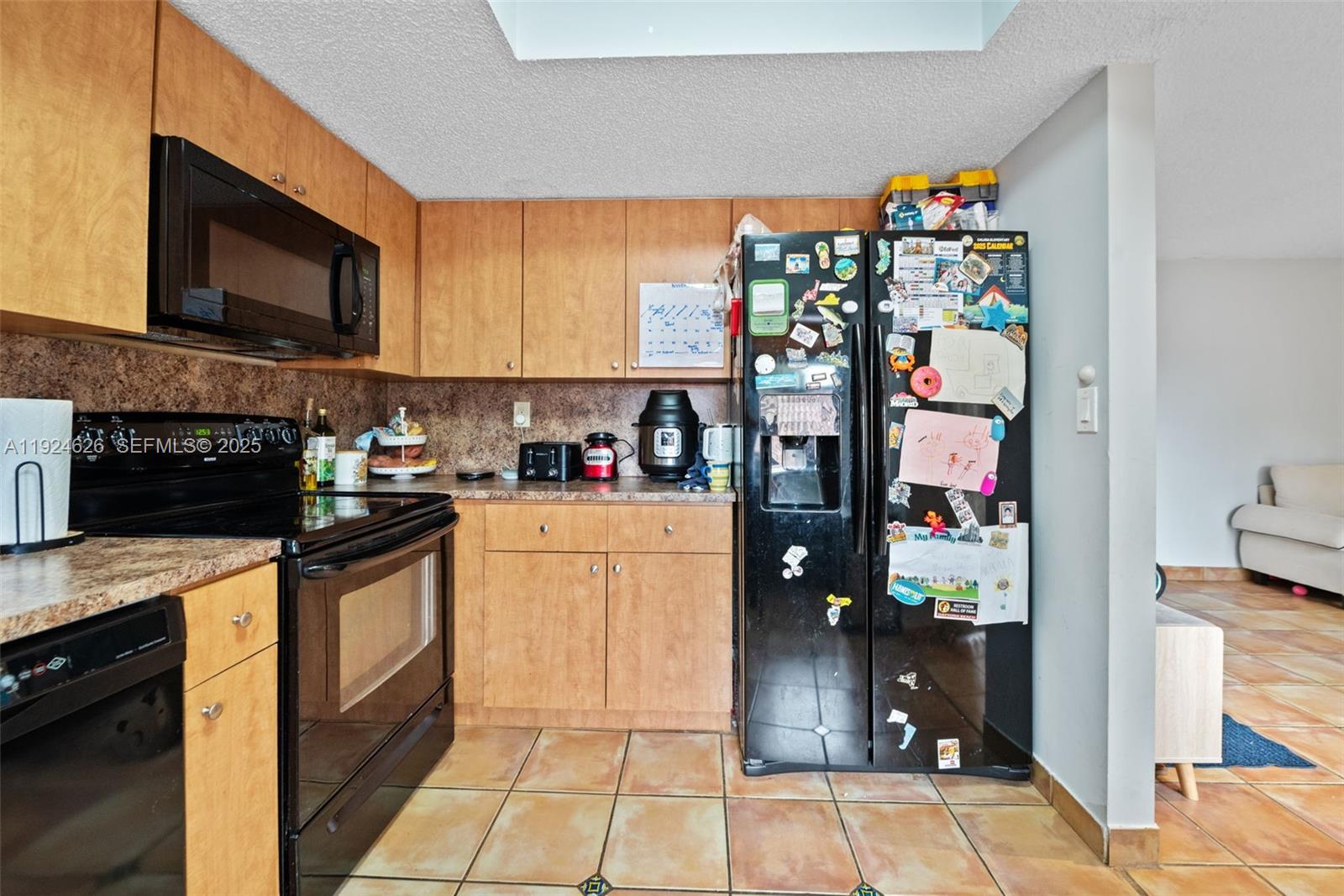 11840 Southwest 80th Street, Unit 526 Miami, FL 33183 - Photo 5 of 25 a kitchen with stainless steel appliances granite countertop a refrigerator and a stove top oven