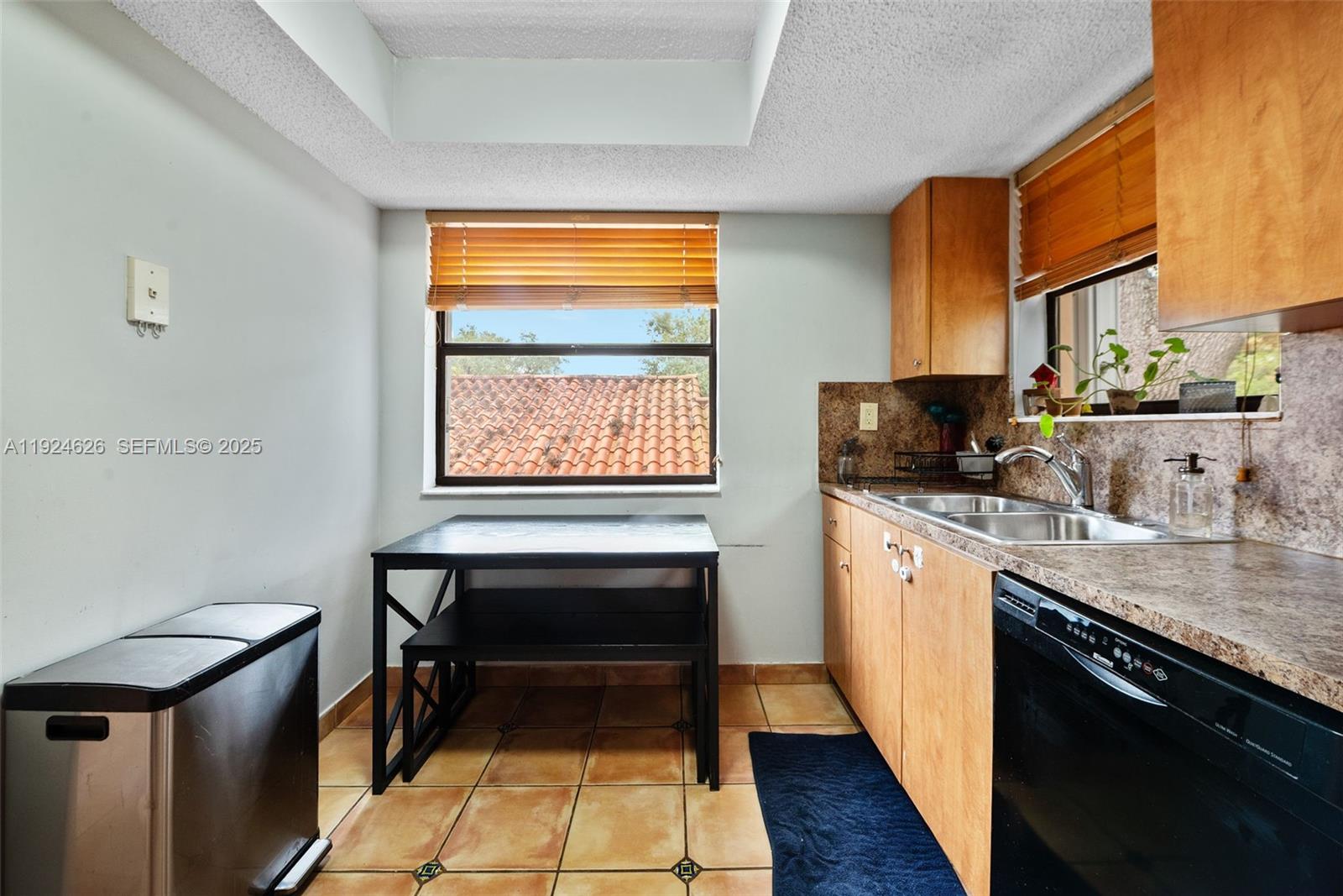 11840 Southwest 80th Street, Unit 526 Miami, FL 33183 - Photo 6 of 25 a kitchen with stainless steel appliances granite countertop sink stove top oven and cabinets