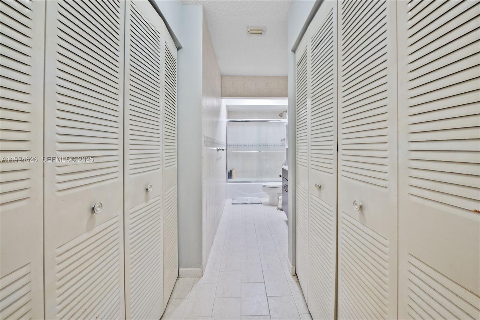 11840 Southwest 80th Street, Unit 526 Miami, FL 33183 - Photo 10 of 25 a view of a bathroom from a hallway