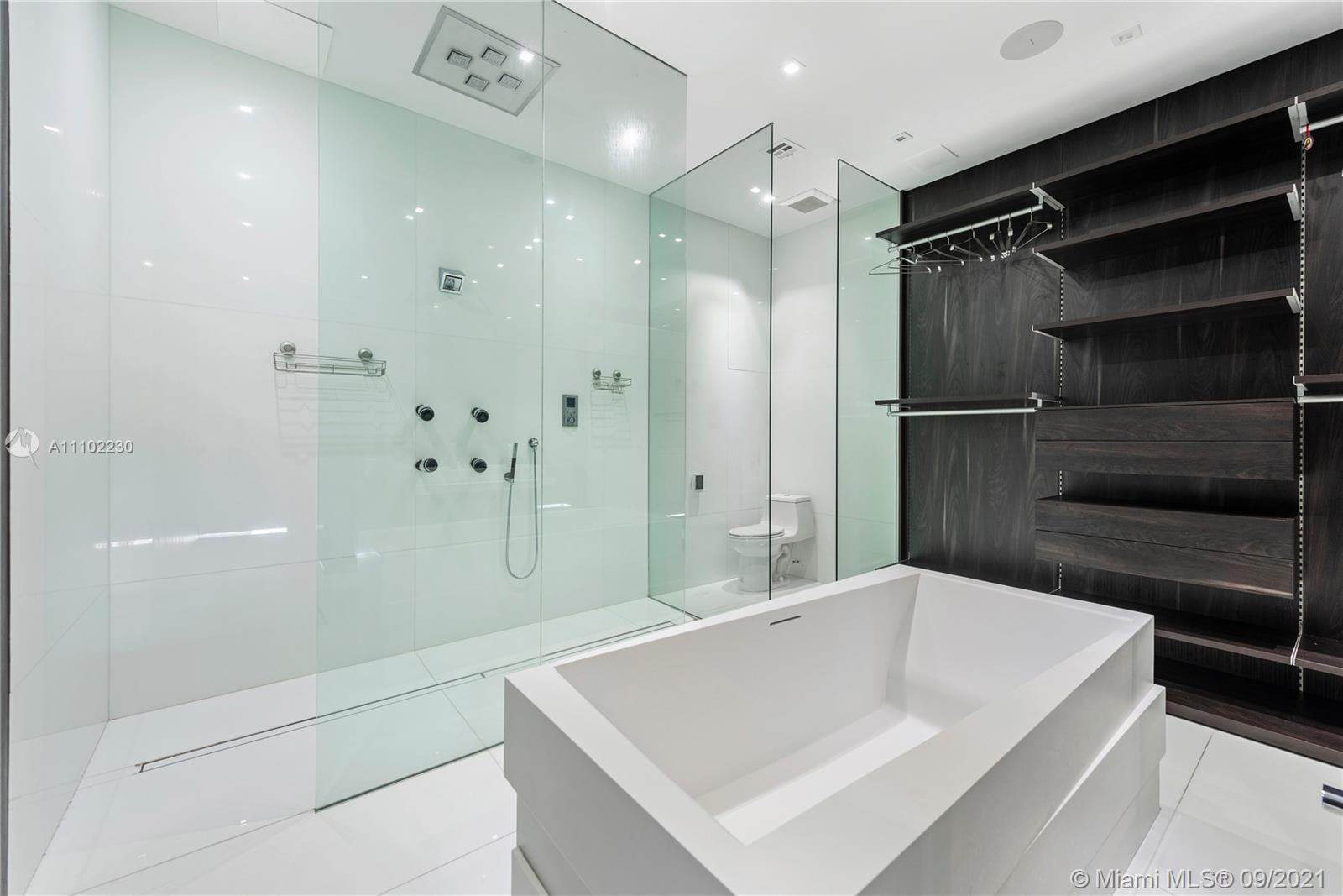 900 Brickell Key Boulevard, Unit 2902 Miami, FL 33131 - Photo 18 of 32 a bathroom with a bathtub and a shower
