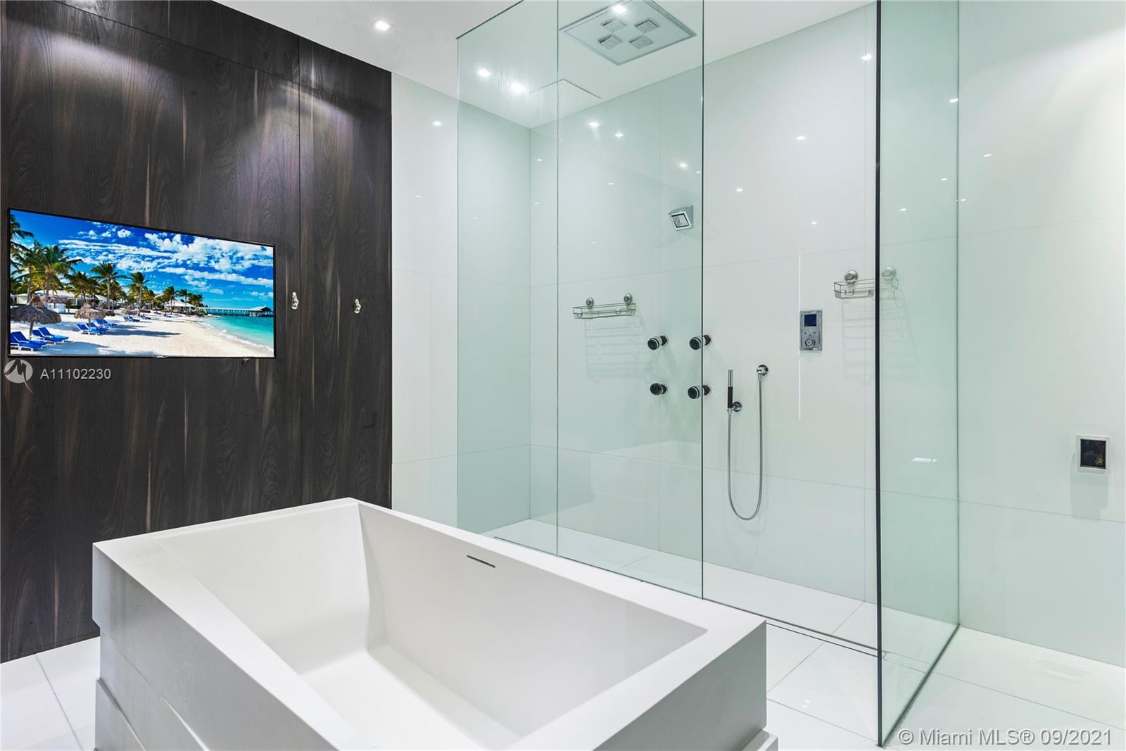 900 Brickell Key Boulevard, Unit 2902 Miami, FL 33131 - Photo 20 of 32 a bathroom with a tub and shower