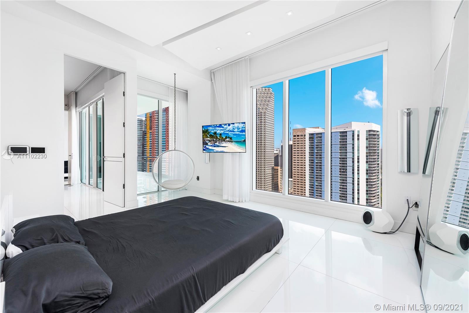 900 Brickell Key Boulevard, Unit 2902 Miami, FL 33131 - Photo 21 of 32 a bedroom with a large bed and a large window
