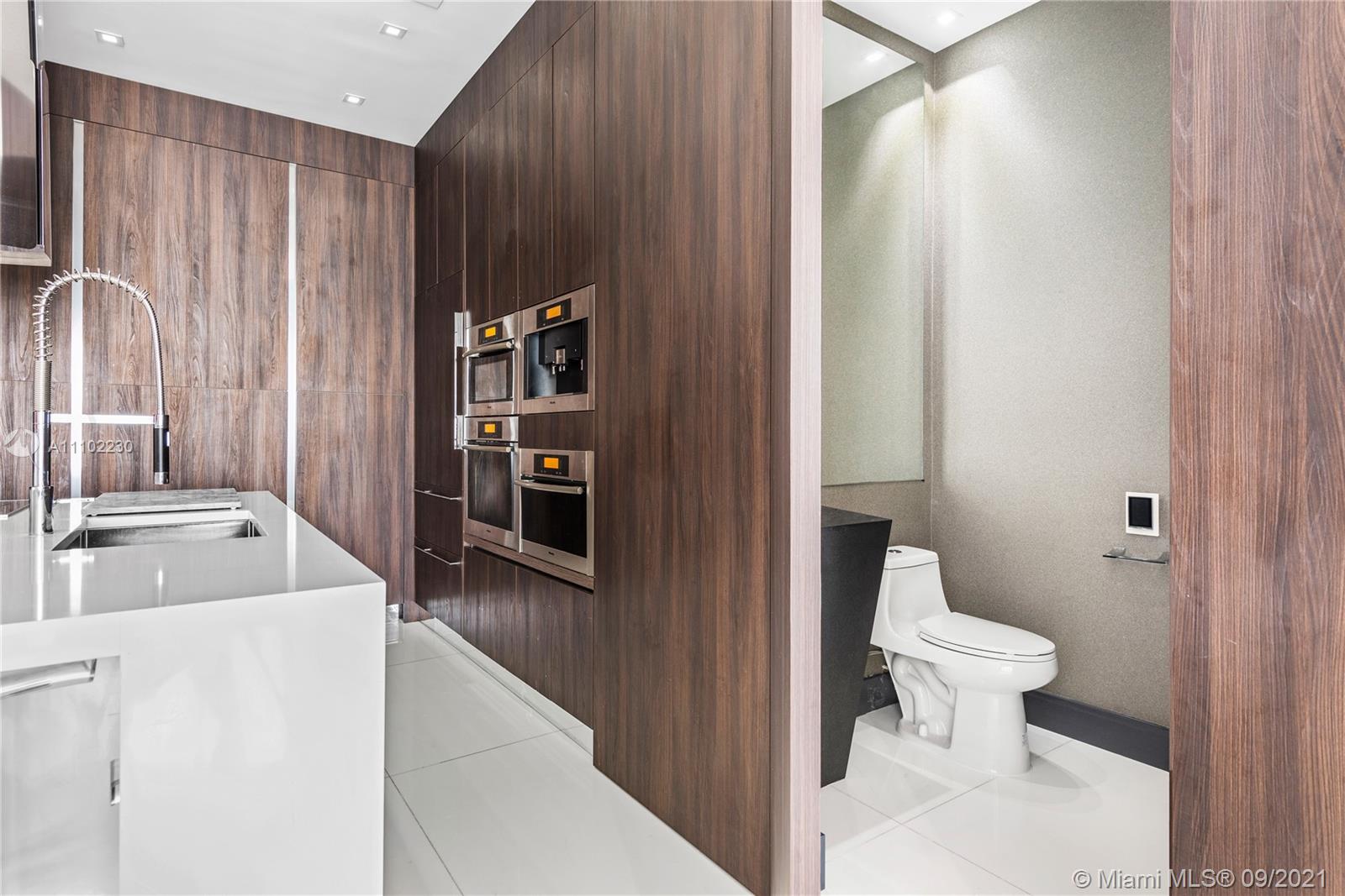 900 Brickell Key Boulevard, Unit 2902 Miami, FL 33131 - Photo 27 of 32 a bathroom with a sink a toilet and shower