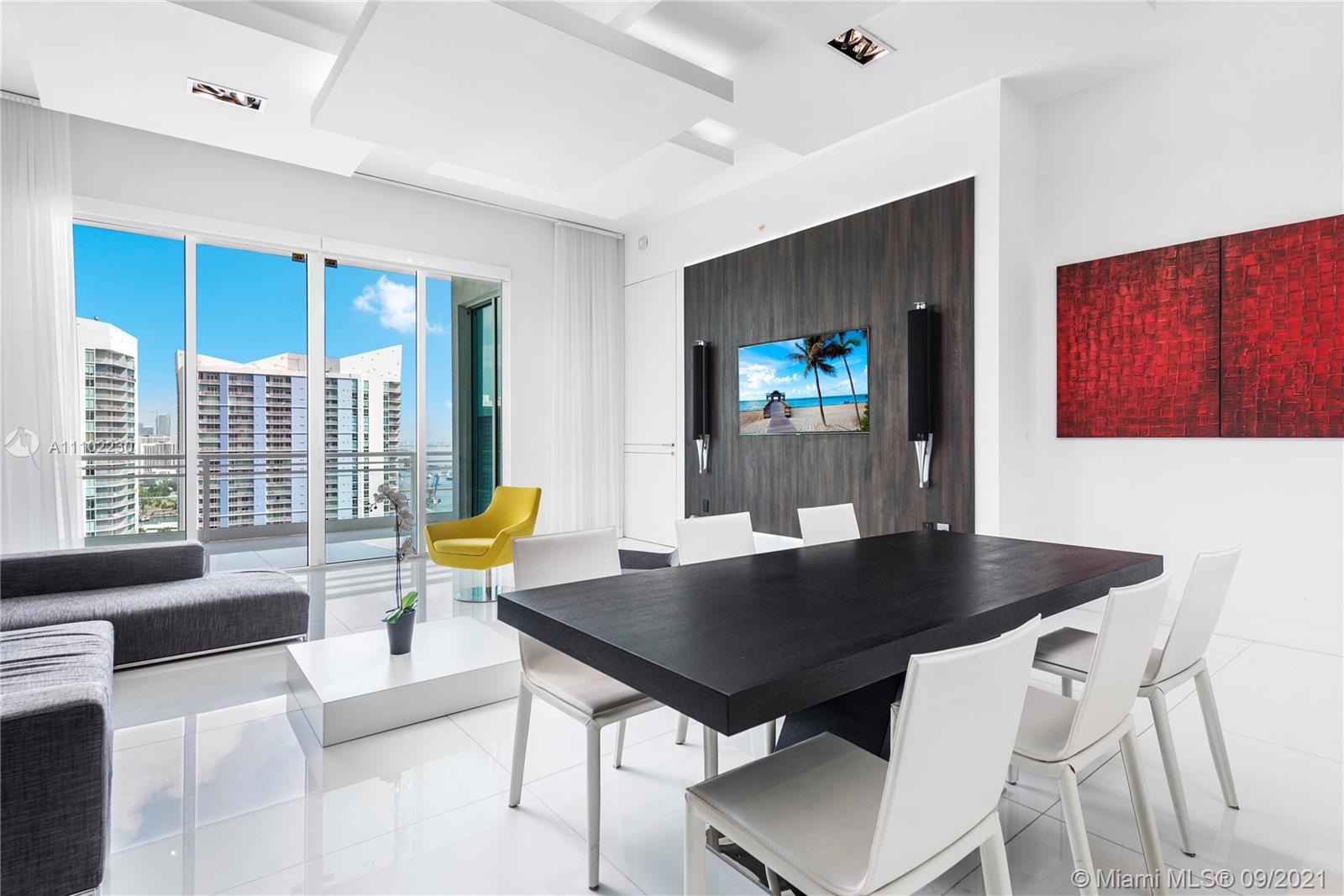 900 Brickell Key Boulevard, Unit 2902 Miami, FL 33131 - Photo 28 of 32 a living room with dining table and a couch