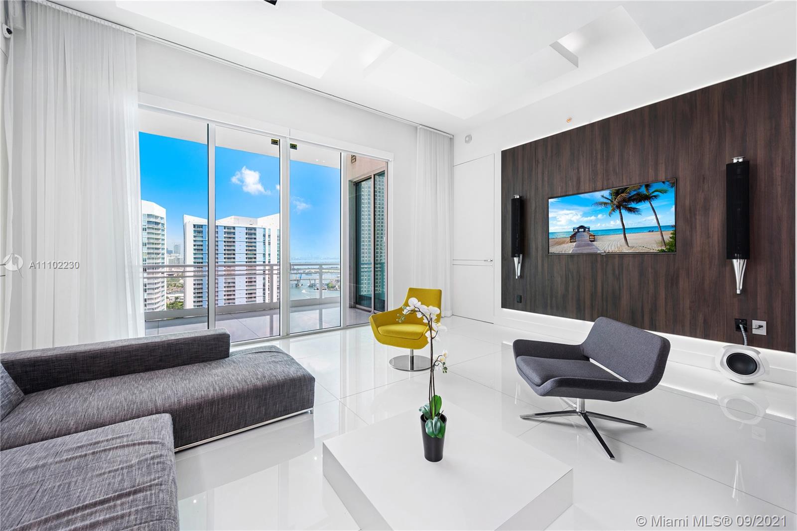 900 Brickell Key Boulevard, Unit 2902 Miami, FL 33131 - Photo 29 of 32 a living room with furniture and a flat screen tv