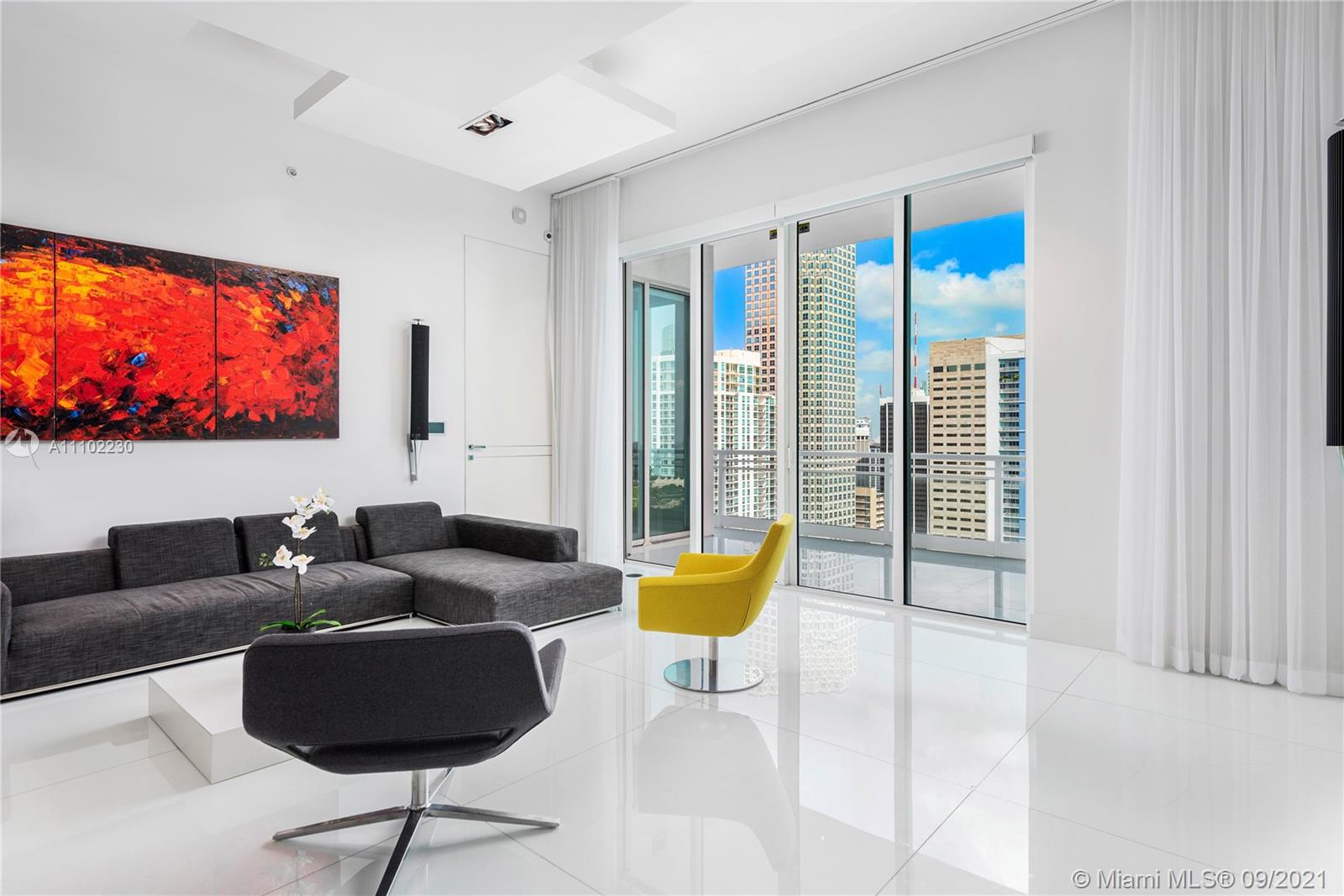 900 Brickell Key Boulevard, Unit 2902 Miami, FL 33131 - Photo 30 of 32 a living room with furniture and a flat screen tv