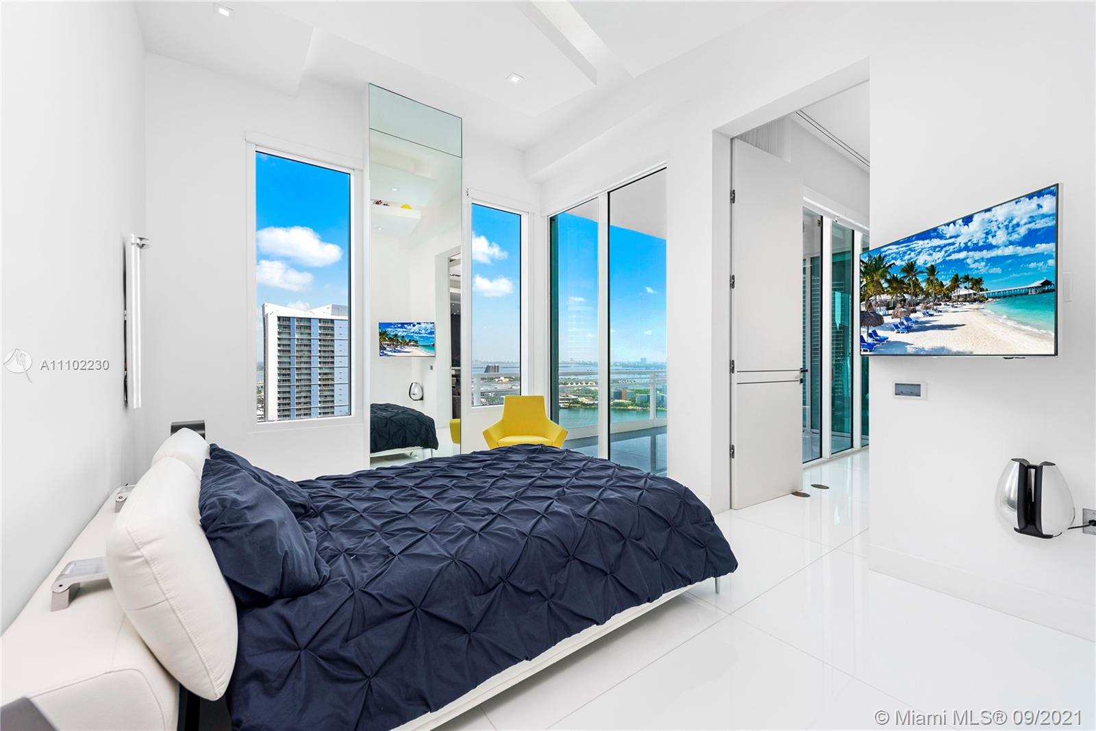 900 Brickell Key Boulevard, Unit 2902 Miami, FL 33131 - Photo 8 of 32 a view of bedroom with furniture and large window