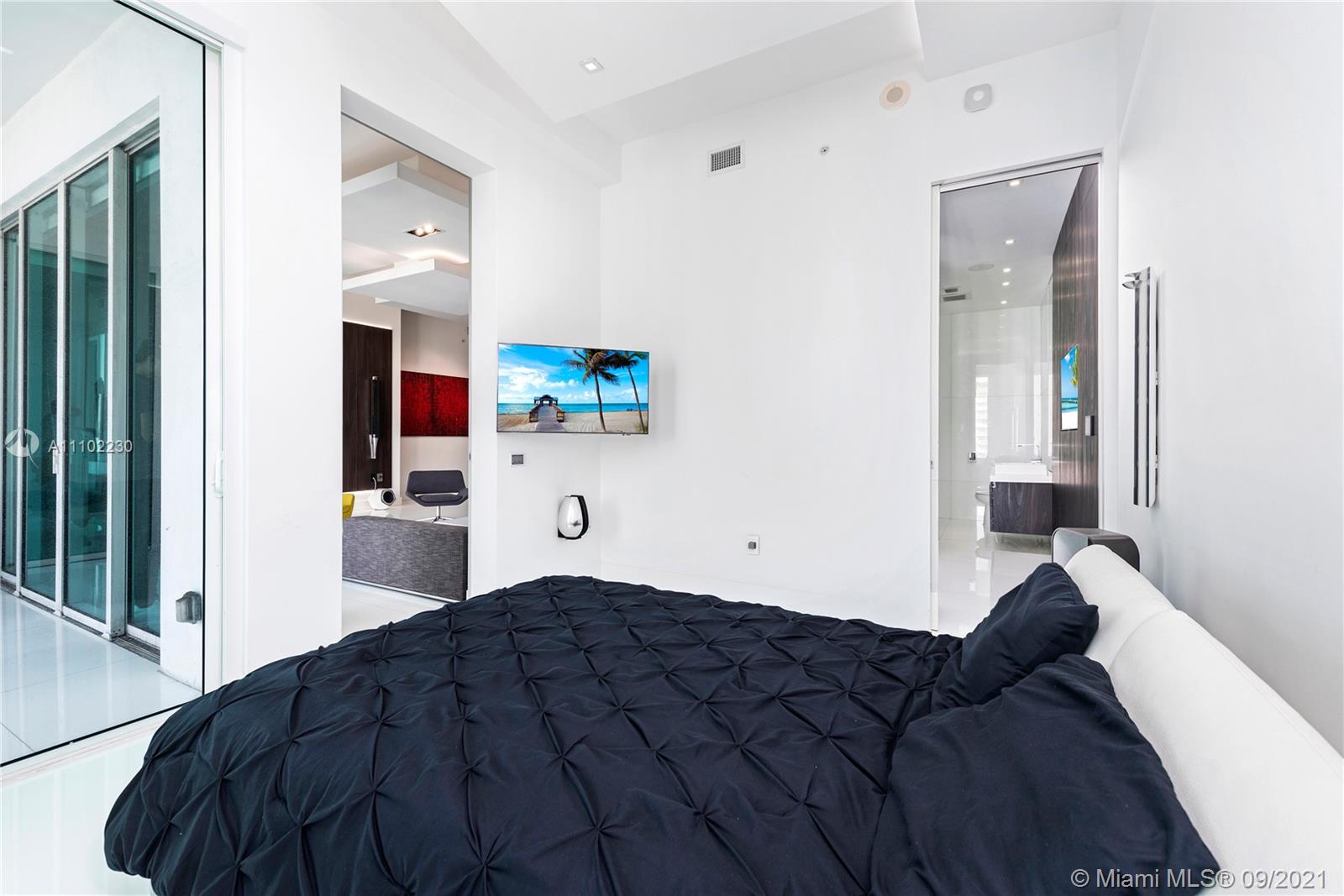 900 Brickell Key Boulevard, Unit 2902 Miami, FL 33131 - Photo 10 of 32 a bedroom with a bed and window