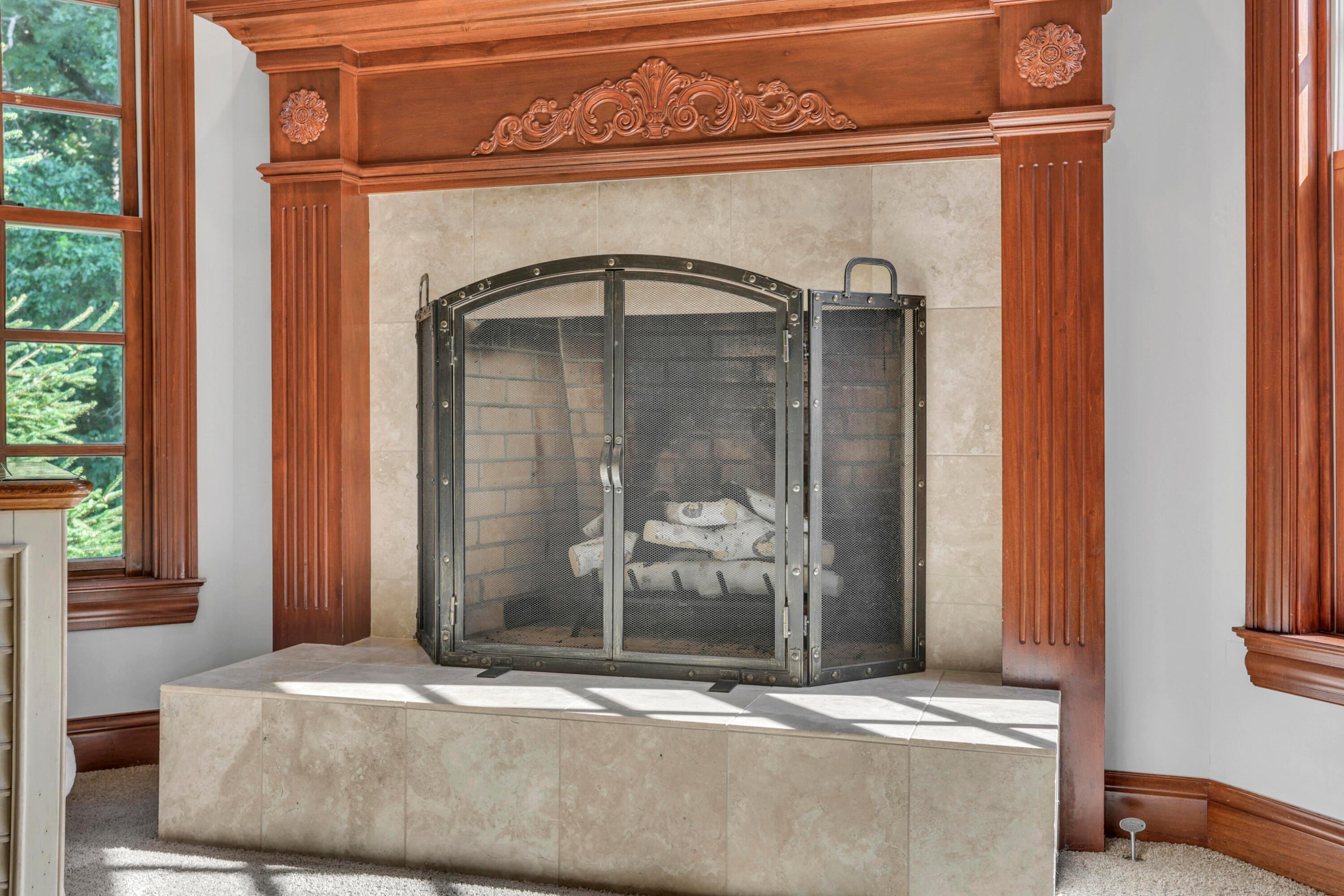 3575 State Rte 37 West Delaware, OH 43015 - Photo 56 of 106 Traditional fireplace featuring an ornate wood mantel, a tiled hearth, and a metal screen
